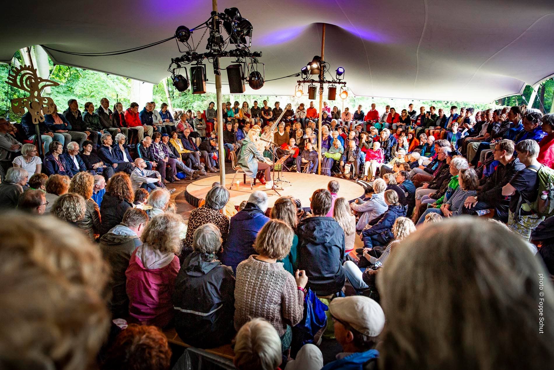 Detail of zipper pull with tan leather and silver rivet.